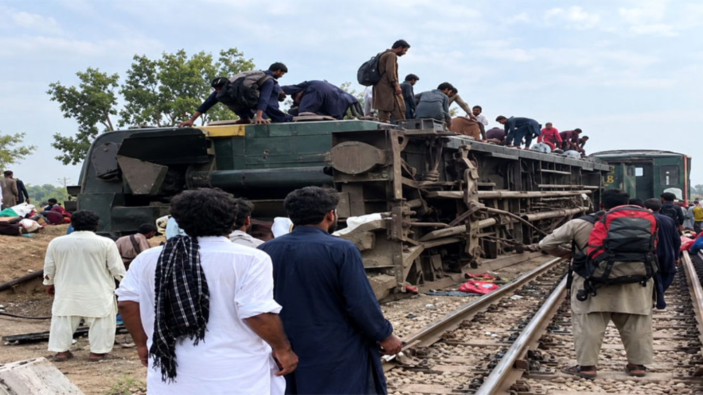 Rescue workers at the site of the Rehman Baba Express derailment near Sher Shah Bridge in Multan, Punjab, on October 13.