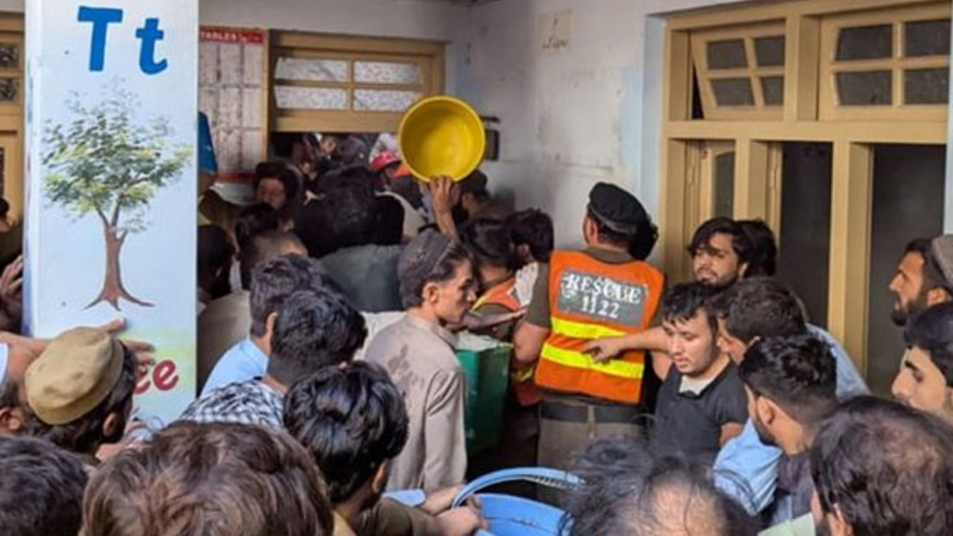 Rescue workers search the rubble of Al-Khair School System in Peshawar after a roof collapse killed children and injured dozen